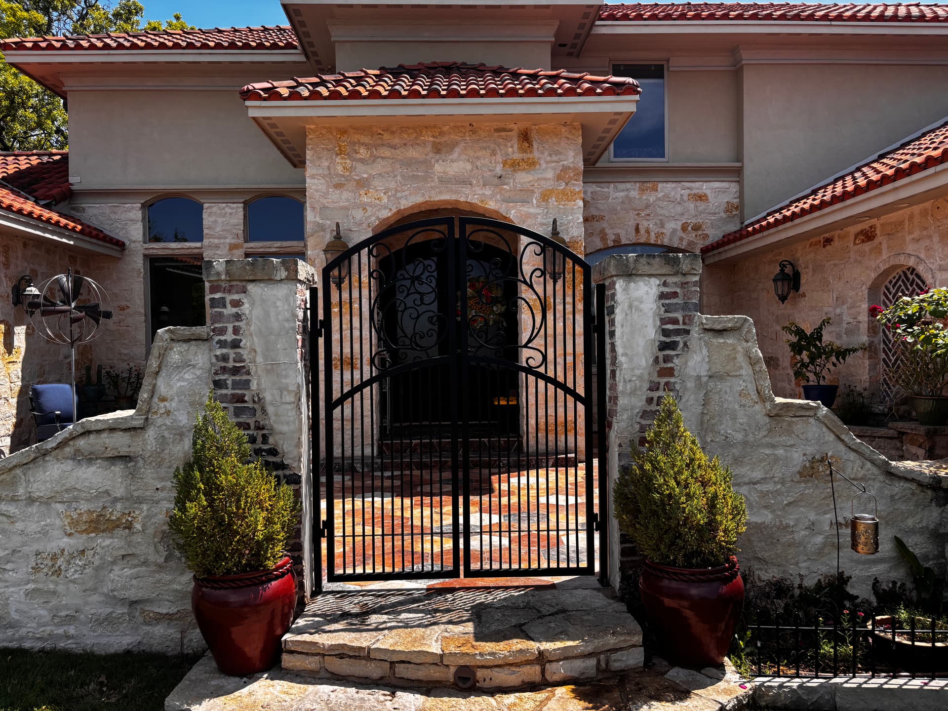 Custom Double-Arch Iron Gate with Hand-Rolled Scrollwork image